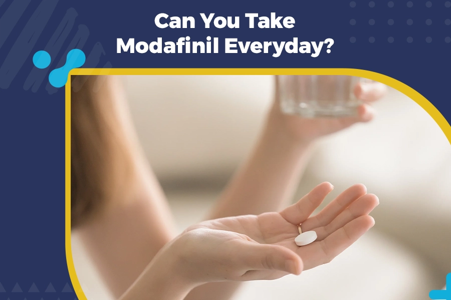 Person holding a tablet with water while considering daily use of Modafinil