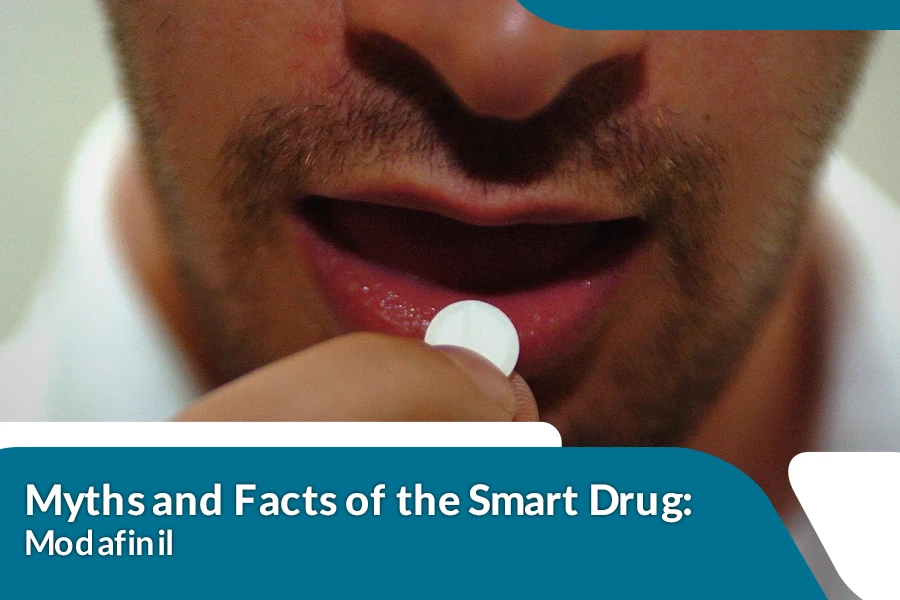 Close-up of a man holding a white pill near his lips, about to take it, with overlaid text reading “Myths and Facts of the Smart Drug: Modafinil.”