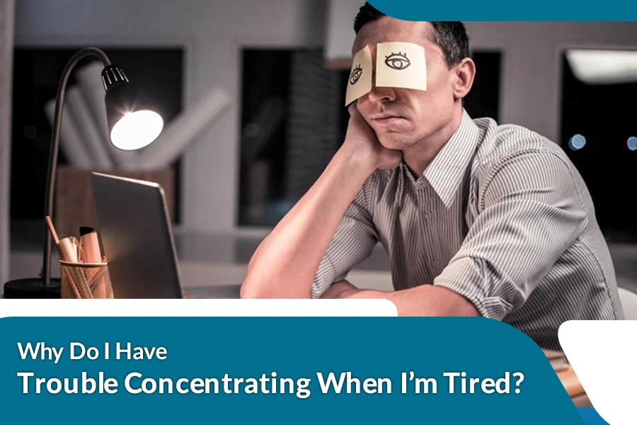 Tired person struggling to concentrate while working at a desk